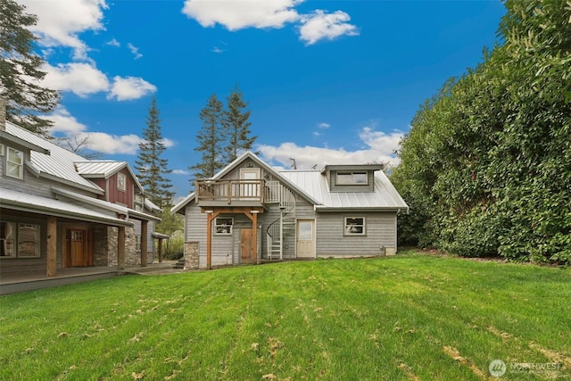 1005 Cavalero Rd, Camano Island, WA 98282 - rear view of property with metal roof, a deck, and a lawn
