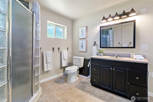 15802 67th Ave NW, Gig Harbor, WA 98332 - full bathroom with a stall shower, baseboards, toilet, and vanity