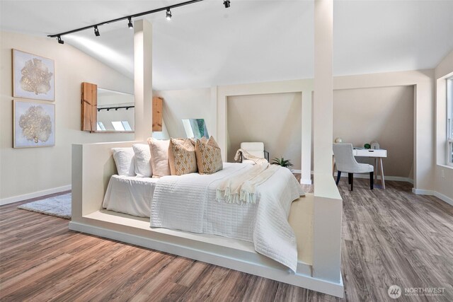 15802 67th Ave NW, Gig Harbor, WA 98332 - bedroom featuring rail lighting, wood finished floors, baseboards, and lofted ceiling