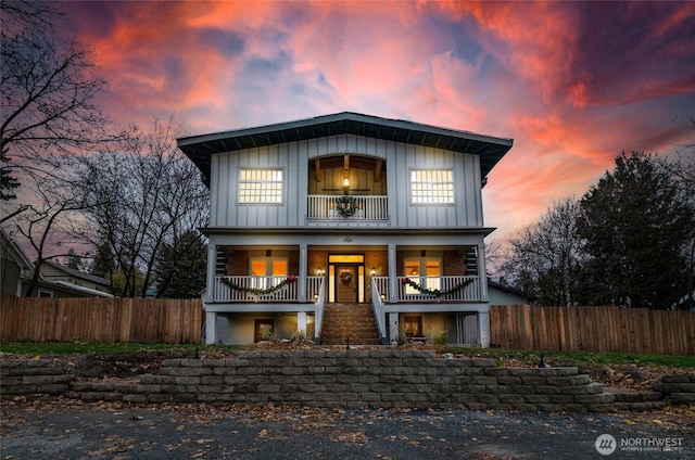640 N Elm St, Colville, WA 99114 - view of front of house with board and batten siding, a porch, stairway, and fence