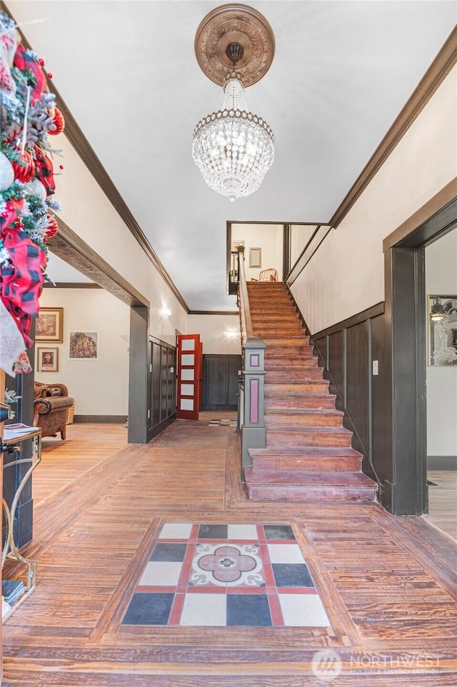 640 N Elm St, Colville, WA 99114 - stairway with baseboards, ornamental molding, and an inviting chandelier