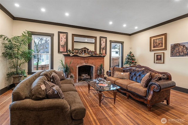 640 N Elm St, Colville, WA 99114 - living room with a healthy amount of sunlight, a brick fireplace, wood finished floors, and ornamental molding