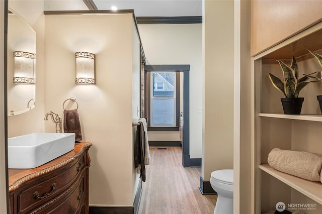 640 N Elm St, Colville, WA 99114 - bathroom featuring vanity, toilet, baseboards, and wood finished floors