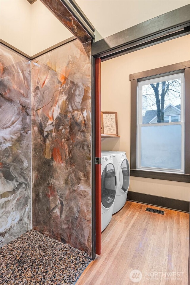 640 N Elm St, Colville, WA 99114 - washroom with laundry area, washer and dryer, visible vents, and wood finished floors