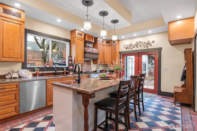 640 N Elm St, Colville, WA 99114 - kitchen with recessed lighting, stainless steel dishwasher, glass insert cabinets, premium range hood, and an island with sink