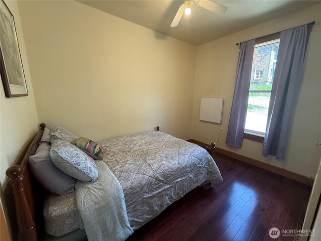 640 N Elm St, Colville, WA 99114 - bedroom with multiple windows, baseboards, a ceiling fan, and hardwood / wood-style flooring