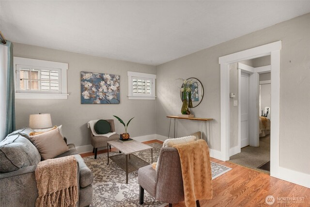 living room with healthy amount of natural light, wood finished floors, and baseboards