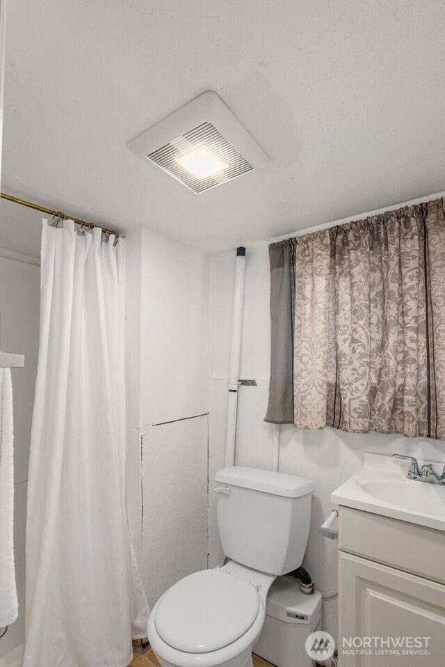 bathroom with toilet and vanity