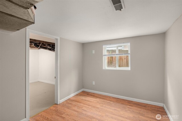 unfurnished bedroom with light wood-style flooring and baseboards