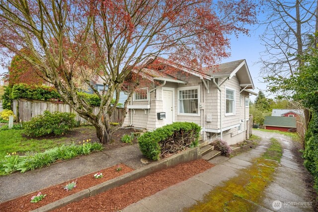 view of front facade with fence and dirt driveway