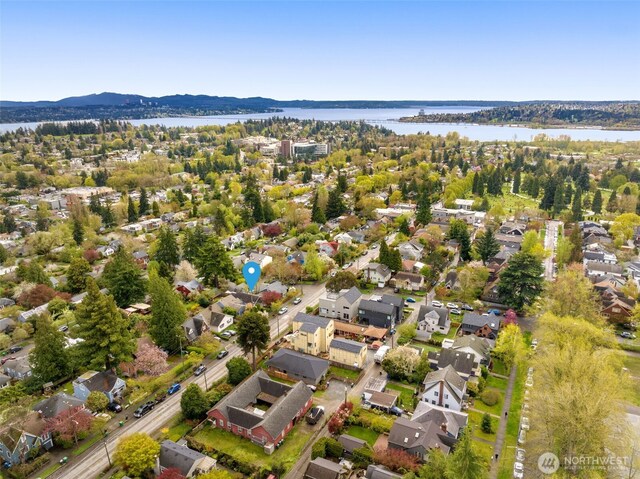 aerial perspective of suburban area featuring a water and mountain view