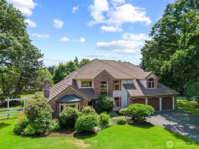 7117 NE 176th Ave, Vancouver, WA 98682 - view of front facade featuring brick siding, a chimney, and asphalt driveway