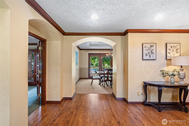 7117 NE 176th Ave, Vancouver, WA 98682 - corridor featuring arched walkways, ornamental molding, wood finished floors, and a textured ceiling