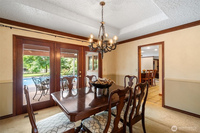 7117 NE 176th Ave, Vancouver, WA 98682 - dining room with a textured ceiling, french doors, light carpet, a chandelier, and a tray ceiling