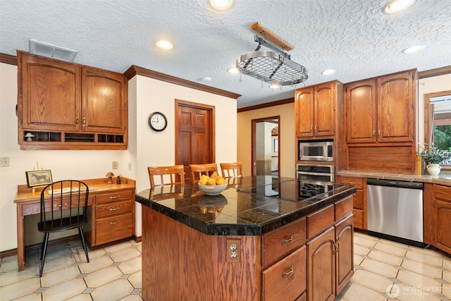 7117 NE 176th Ave, Vancouver, WA 98682 - kitchen with stainless steel appliances, tile countertops, a center island, crown molding, and brown cabinets