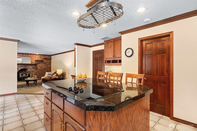 7117 NE 176th Ave, Vancouver, WA 98682 - kitchen with black electric stovetop, a textured ceiling, crown molding, tile countertops, and a center island