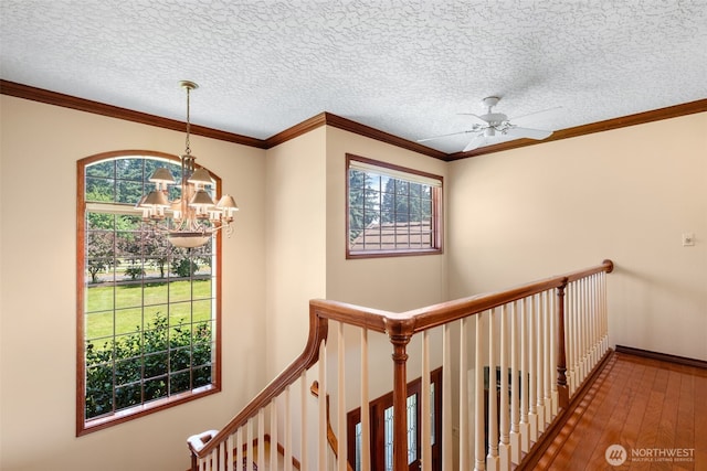 7117 NE 176th Ave, Vancouver, WA 98682 - hall with a chandelier, hardwood / wood-style floors, an upstairs landing, a textured ceiling, and crown molding