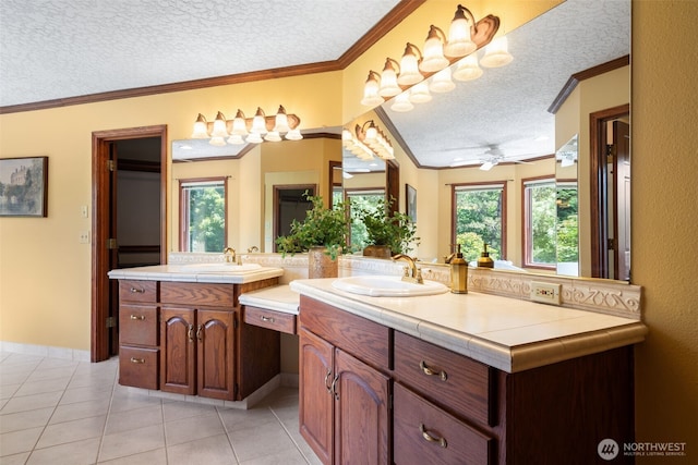 7117 NE 176th Ave, Vancouver, WA 98682 - bathroom featuring a textured ceiling, vanity, tile patterned flooring, crown molding, and a ceiling fan