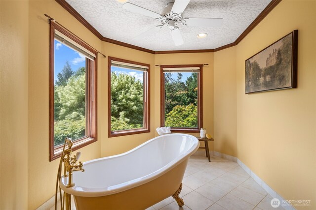 7117 NE 176th Ave, Vancouver, WA 98682 - full bath featuring a freestanding bath, tile patterned floors, a textured ceiling, a ceiling fan, and ornamental molding