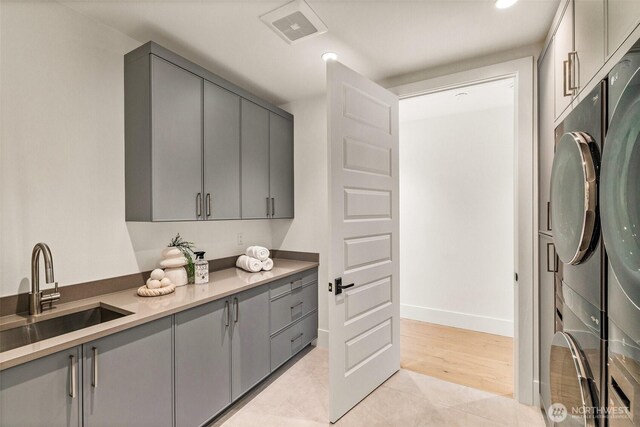 8458 NE 9th St, Medina, WA 98039 - laundry room with cabinet space, baseboards, washer / clothes dryer, light tile patterned floors, and recessed lighting