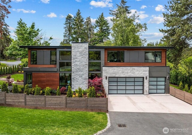 8458 NE 9th St, Medina, WA 98039 - contemporary house with an attached garage, driveway, and stone siding
