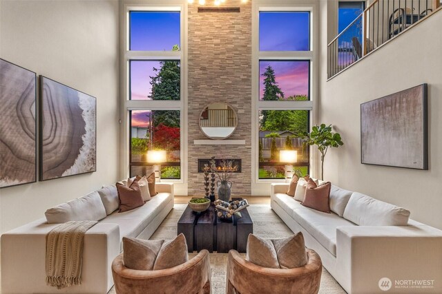 8458 NE 9th St, Medina, WA 98039 - living room featuring a towering ceiling, a fireplace, and healthy amount of natural light