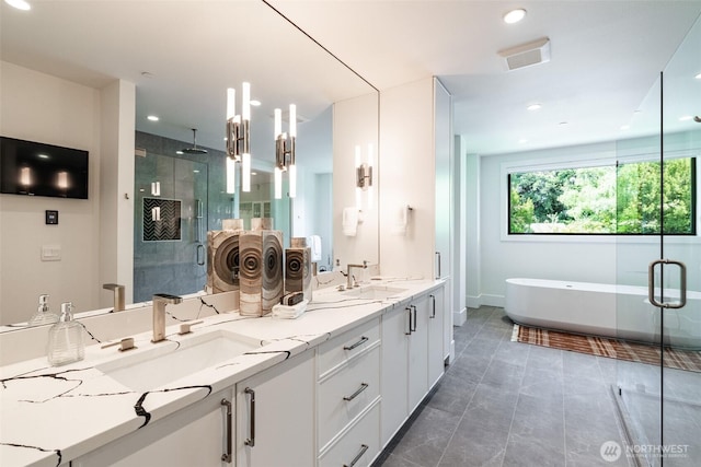 8458 NE 9th St, Medina, WA 98039 - bathroom featuring a shower stall, double vanity, a soaking tub, recessed lighting, and baseboards