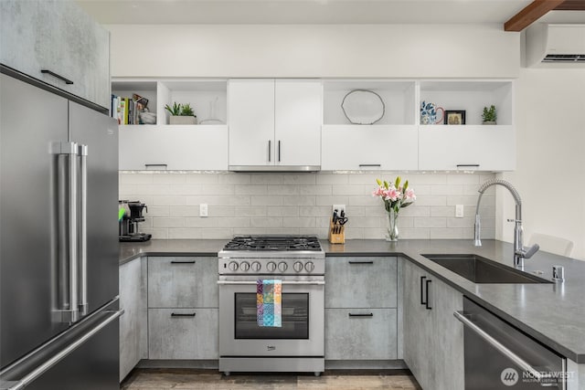 kitchen featuring stainless steel appliances, open shelves, a sink, dark countertops, and a wall mounted air conditioner