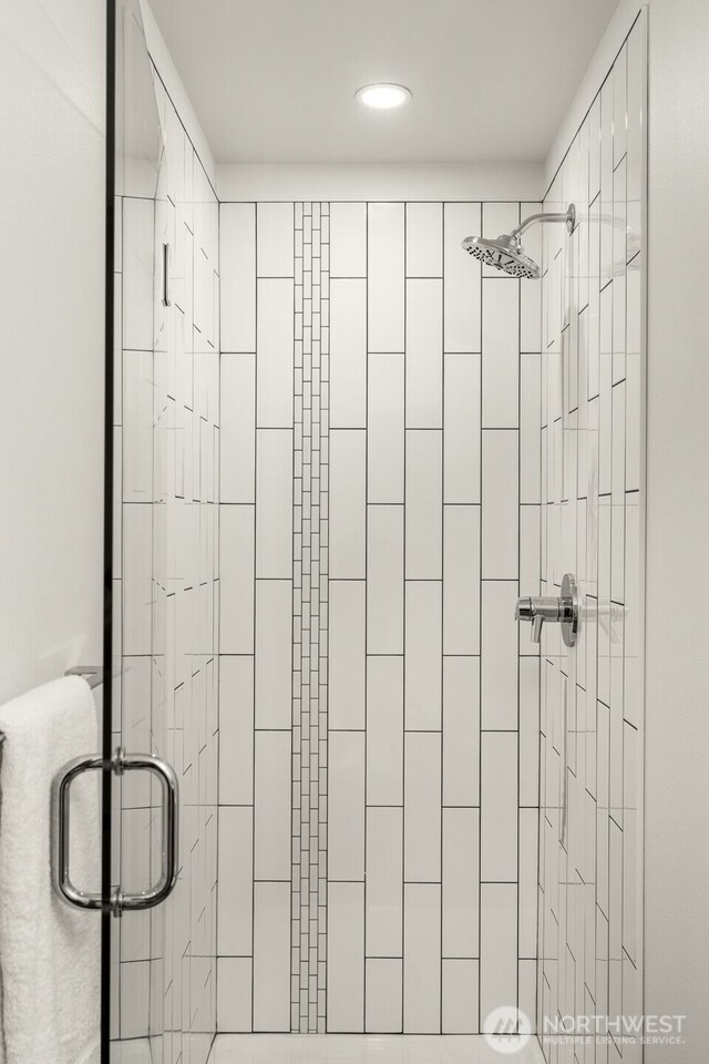 full bath with a shower stall and recessed lighting