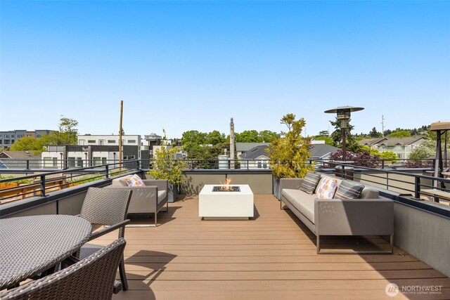 deck featuring an outdoor living space with a fire pit and a residential view