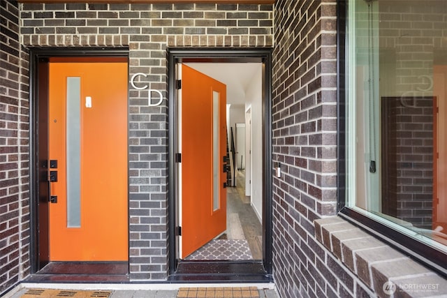 entrance to property with brick siding and elevator