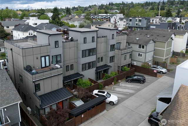 view of property with uncovered parking and a residential view