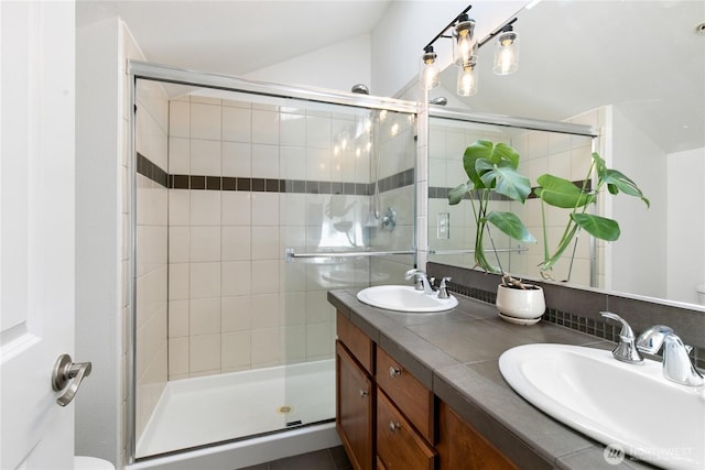 418 11th Ave E Unit B, Seattle, WA 98102 - full bathroom featuring a stall shower, double vanity, decorative backsplash, and toilet