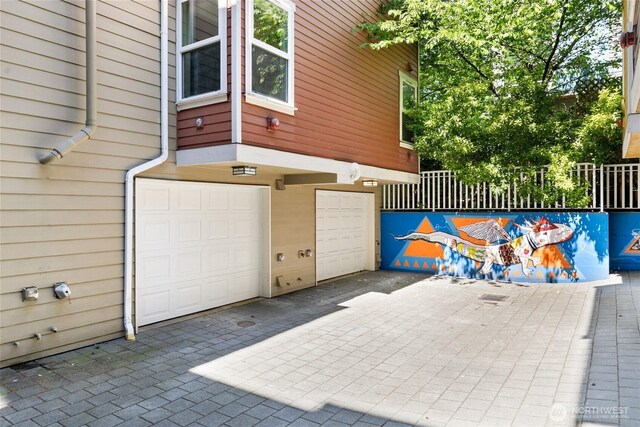 418 11th Ave E Unit B, Seattle, WA 98102 - garage featuring driveway and fence