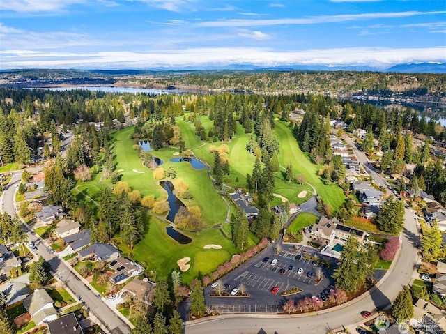 aerial perspective of suburban area featuring a nearby body of water and a golf club