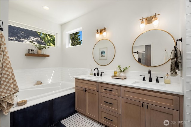 bathroom featuring a garden tub and double vanity