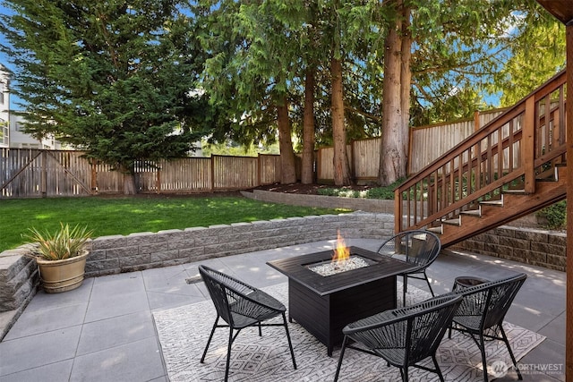 view of patio / terrace with an outdoor fire pit and stairway