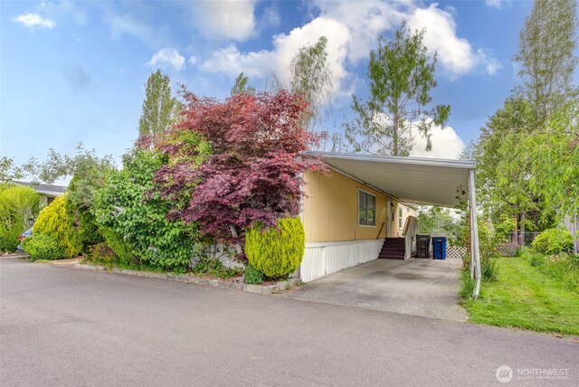 415 Lake View Rd Unit K8, Lynnwood, WA 98087 - view of home's exterior featuring an attached carport, driveway, and fence