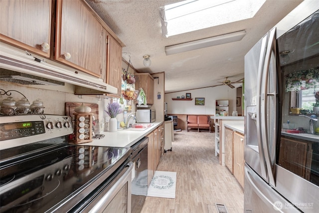 415 Lake View Rd Unit K8, Lynnwood, WA 98087 - kitchen featuring stainless steel appliances, under cabinet range hood, light wood-type flooring, light countertops, and a sink