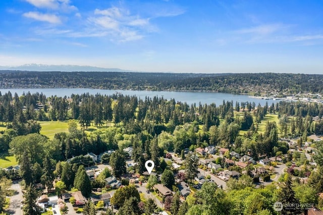 bird's eye view with a water view, a residential view, and a wooded view