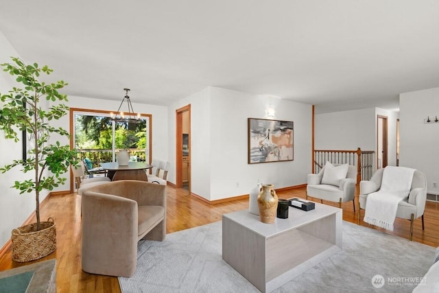living room with baseboards and light wood-type flooring