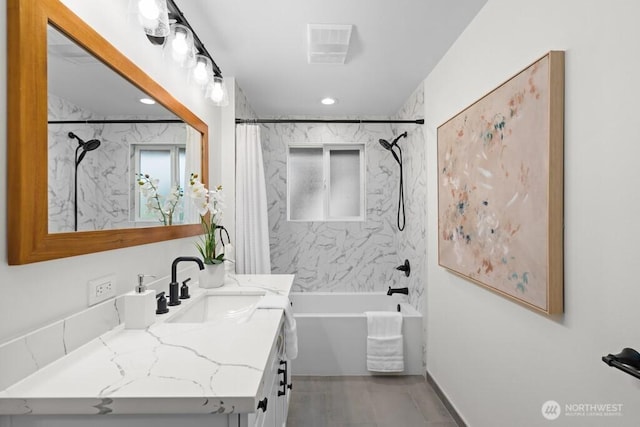 bathroom with vanity, recessed lighting, visible vents, and shower / bath combo