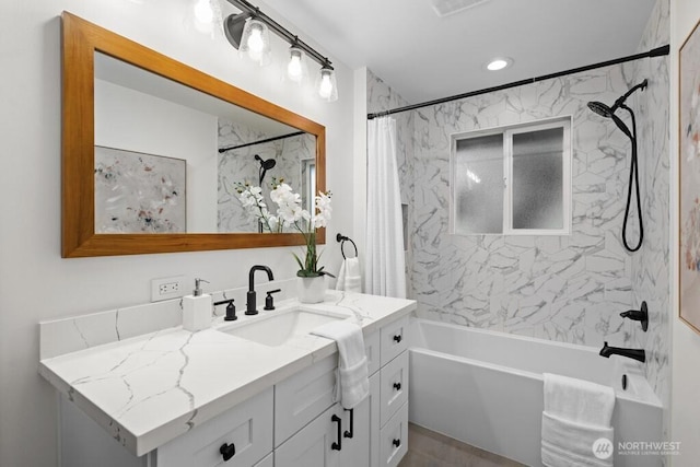 bathroom with shower / tub combo, vanity, and recessed lighting