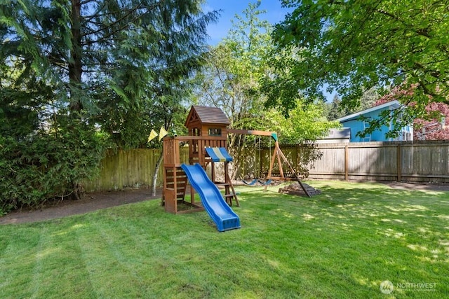 view of play area with a fenced backyard and a lawn