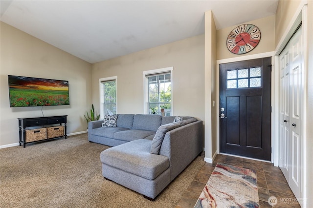 carpeted foyer with vaulted ceiling, baseboards, and healthy amount of natural light