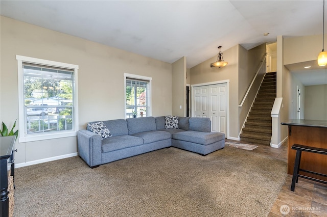living area with stairway, vaulted ceiling, baseboards, and carpet flooring