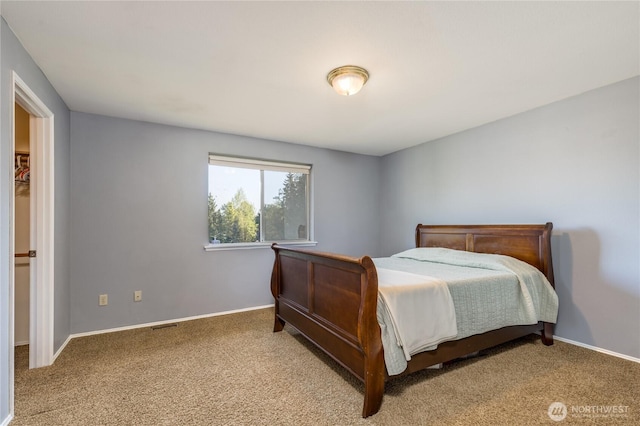 carpeted bedroom featuring baseboards