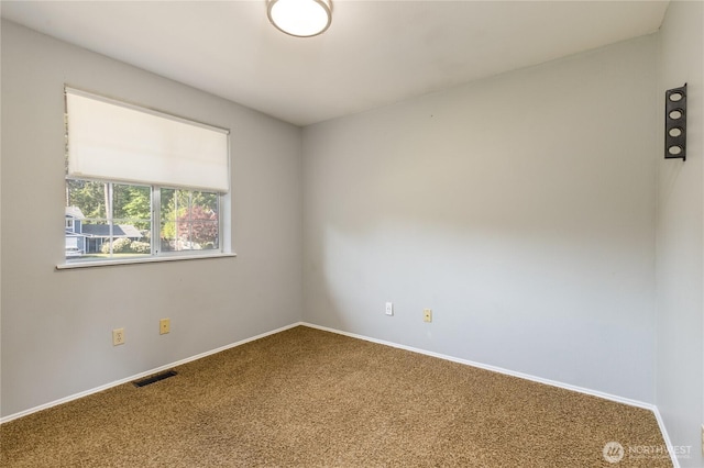 carpeted empty room with baseboards