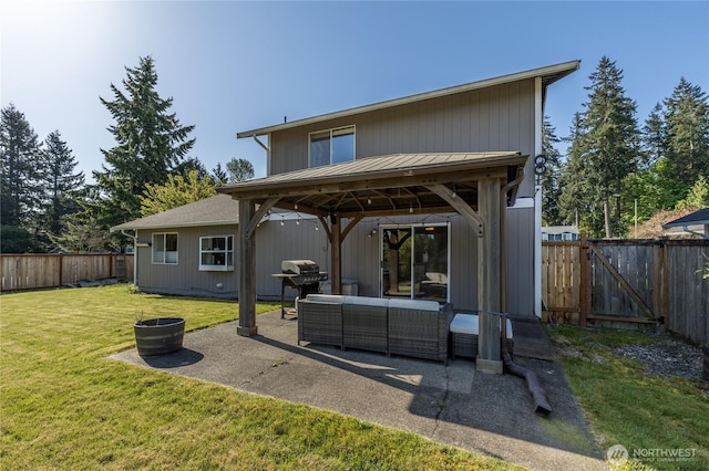 back of property featuring a gazebo, an outdoor living space, a patio, and a gate