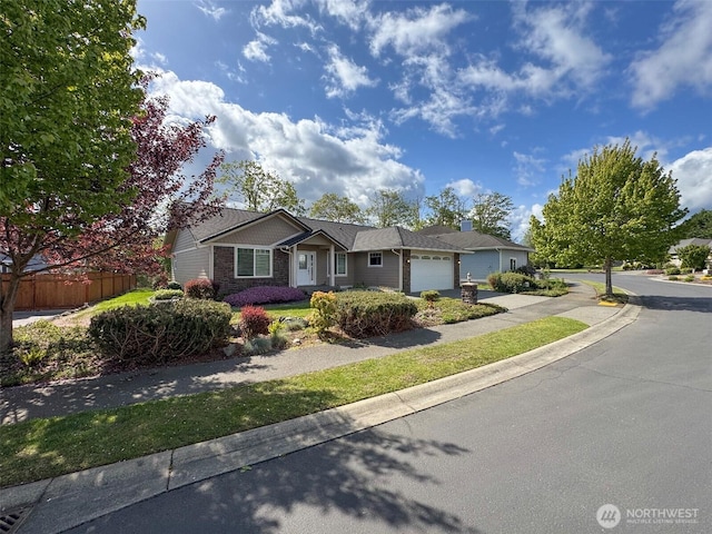 ranch-style house with a garage, fence, and driveway